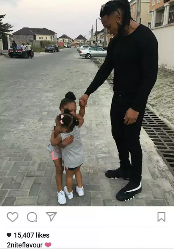 Cute photo of Flavour watching his daughters hug each other